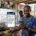 Featured image alt text Nigerian business owner reading an AI assistant answer on a phone instead of a search results page